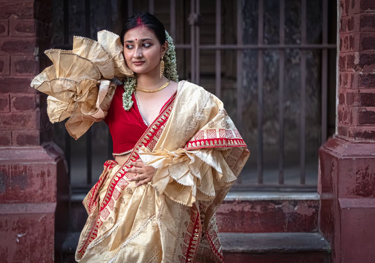 Crafting Captivating Headlines: Your awesome post title goes here Portrait of a woman in traditional Bengali attire with saree and jewelry, showcasing Indian heritage.